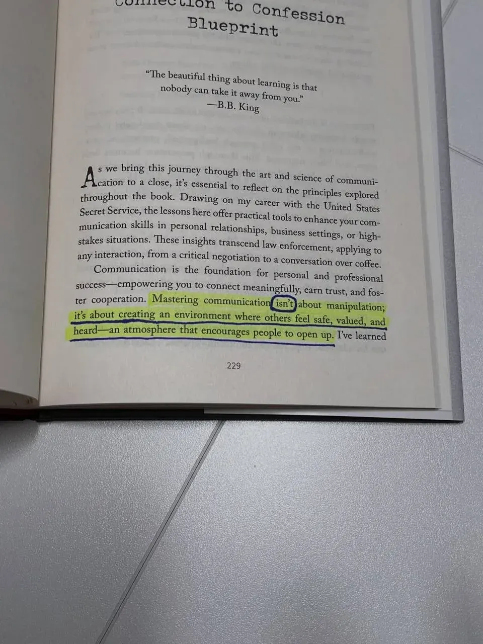 Portrait photo of an open nonfiction book page about communication principles and learning Portrait photo of an open nonfiction book page about communication principles and learning
