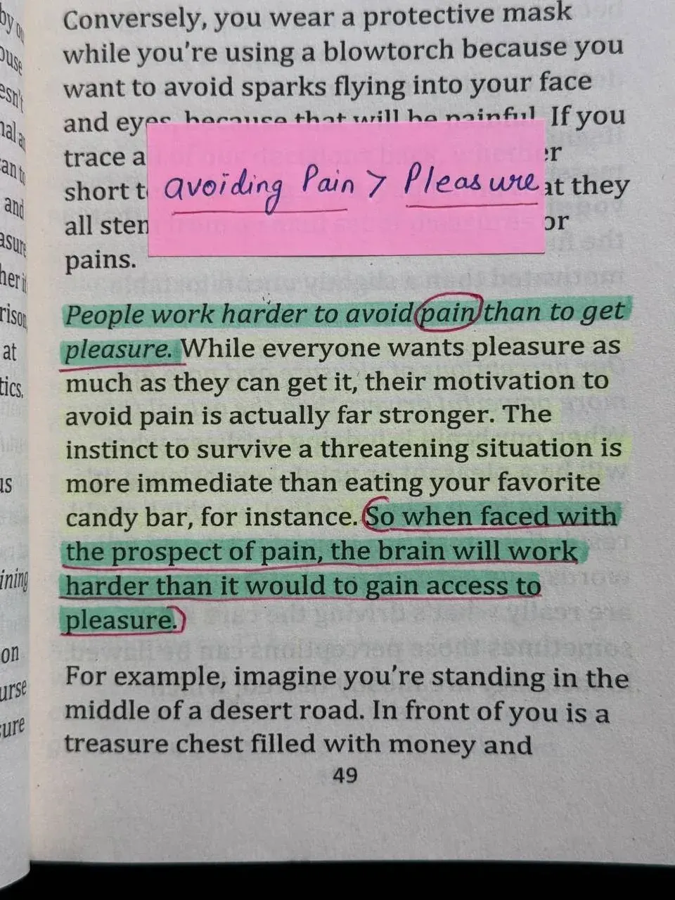 Close-up of a book page discussing how people work harder to avoid pain than to gain pleasure Close-up of a book page discussing how people work harder to avoid pain than to gain pleasure