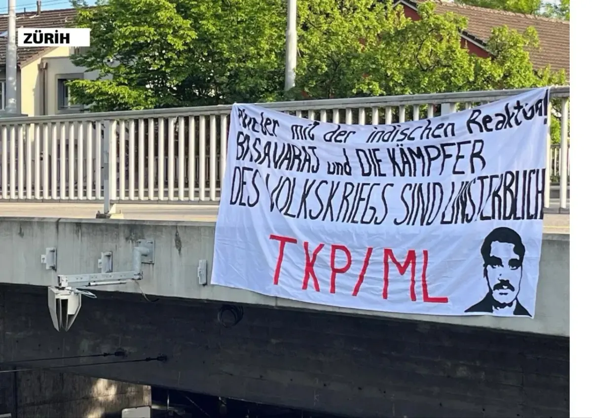 Outdoor protest-style banner with writing and a silhouette portrait hanging from a railing Outdoor protest-style banner with writing and a silhouette portrait hanging from a railing